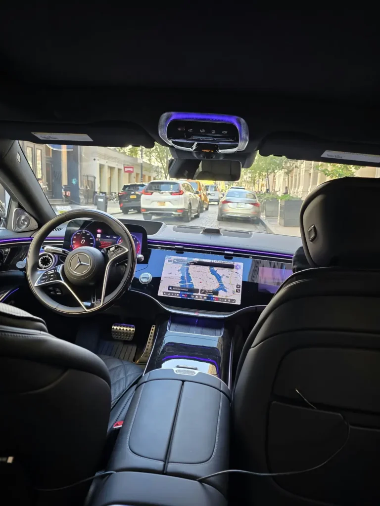 View from the rear seat of the MZ RIDE Mercedes S-Class toward the cockpit on a Manhattan street
